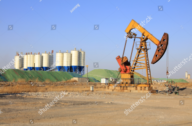 stock-photo-pumping-unit-and-bituminous-concrete-mixing-station-under-blue-sky-in-oilfield-398913367